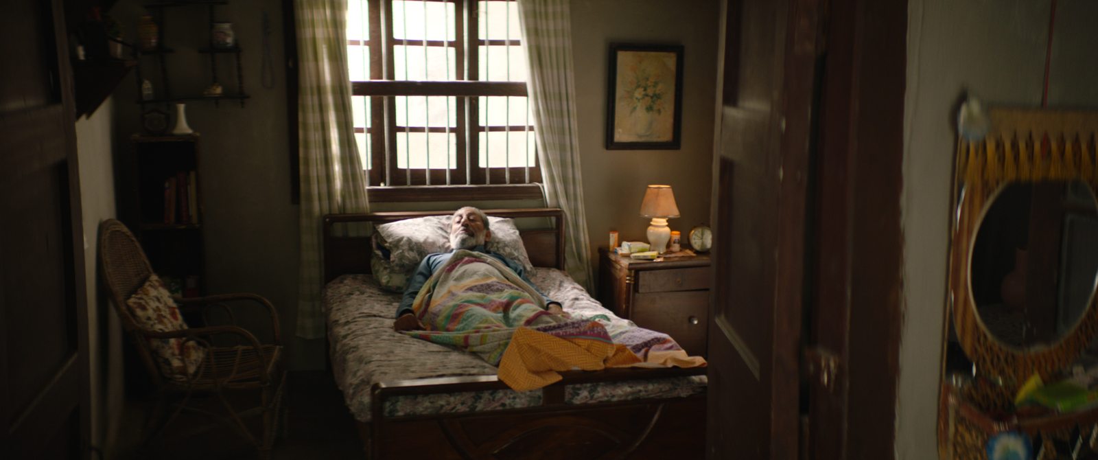 Atmospheric film still from JYOTI showing a dim interior
